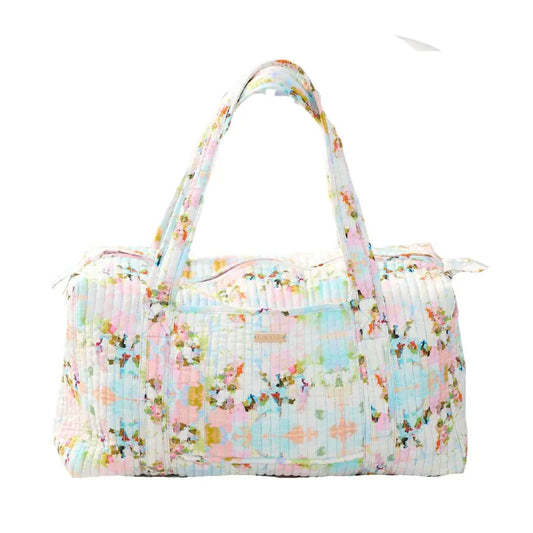 Floral patterned duffel bag on a white background