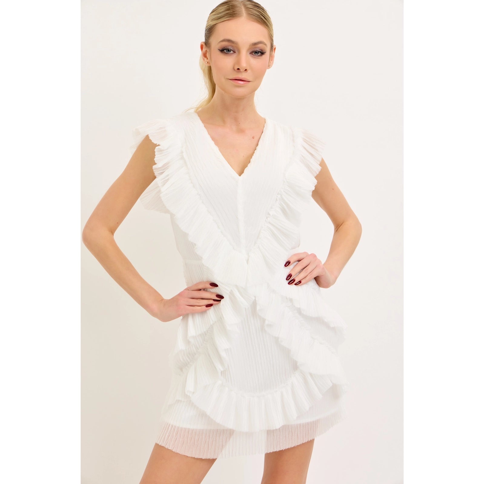 Model wearing white boutique bridal lace mini dress