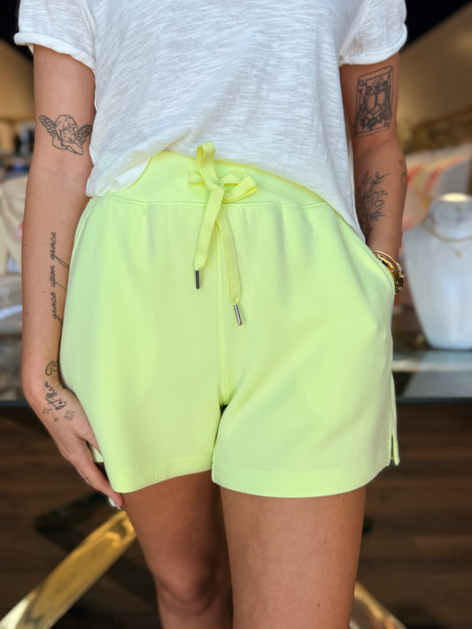 model wearing lime green shorts