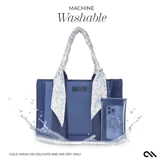 Blue handbag with floral accents and phone case on a white background, featuring the text 'Machine Washable'.