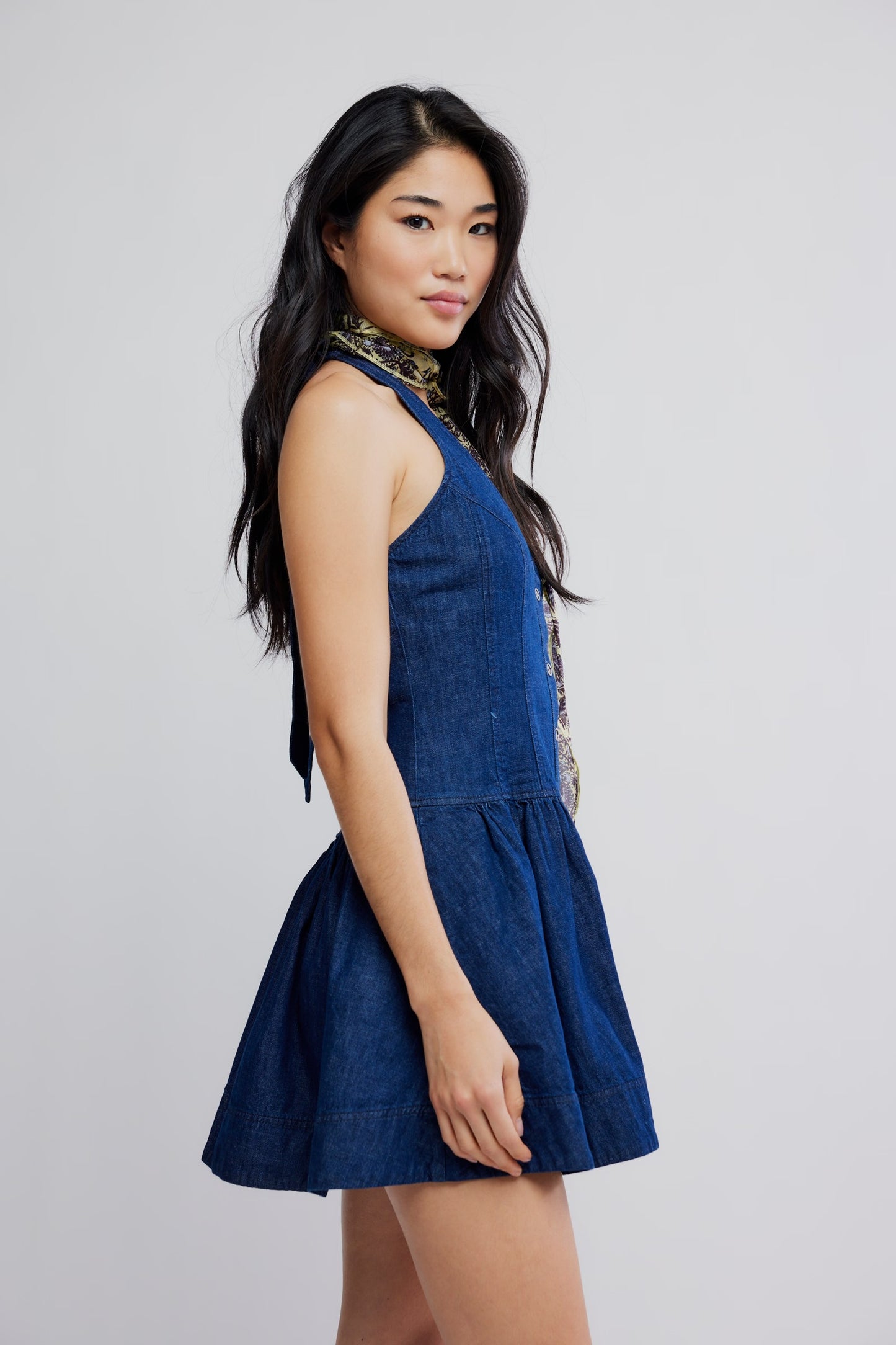 Woman wearing a blue dress against a plain background