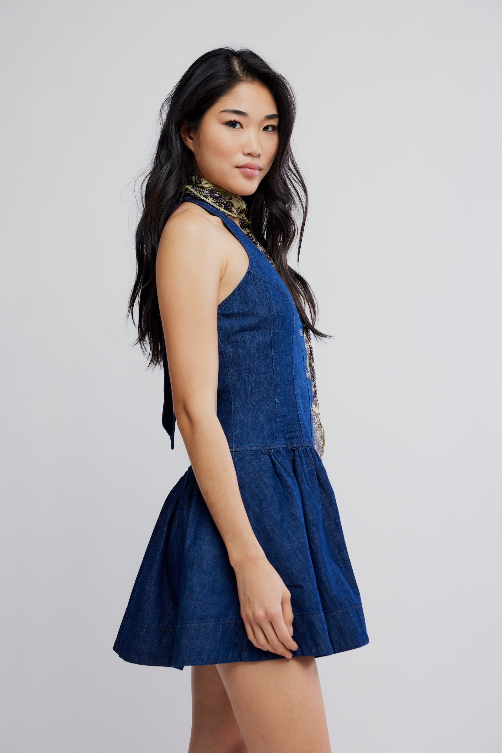 Woman wearing a blue dress against a plain background