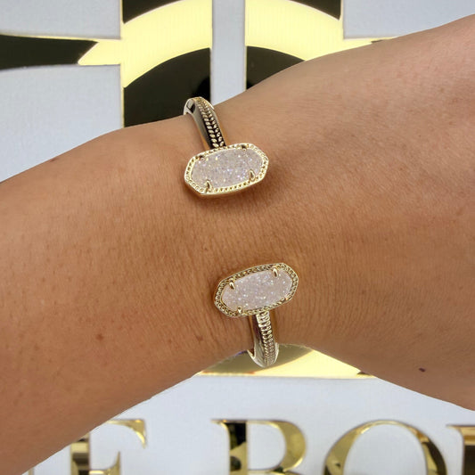 Gold bracelet on a wrist with a blurred background