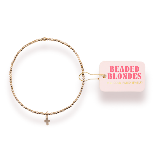 Gold bracelet with a small charm on a white background, featuring 'Beaded Blondes' packaging.