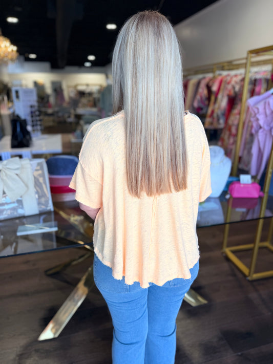 Woman facing backwards with yellow top and blue jeans 