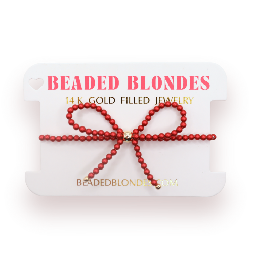 Red beaded bracelet with gold clasp on a 'Beaded Blondes' branded card.