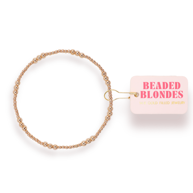 Gold beaded bracelet with 'Beaded Blondes' label on a white background