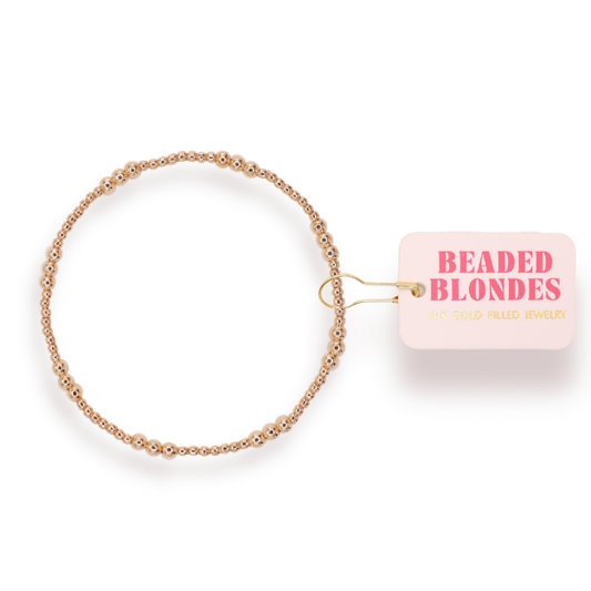 Gold beaded bracelet with 'Beaded Blondes' label on a white background