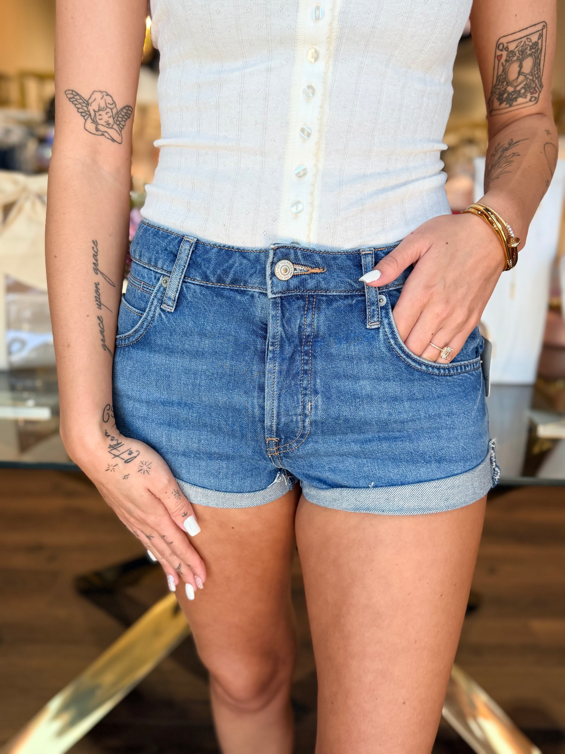 model wearing medium wash denim shorts