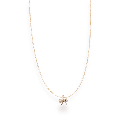 Gold necklace with a small pendant on a white background
