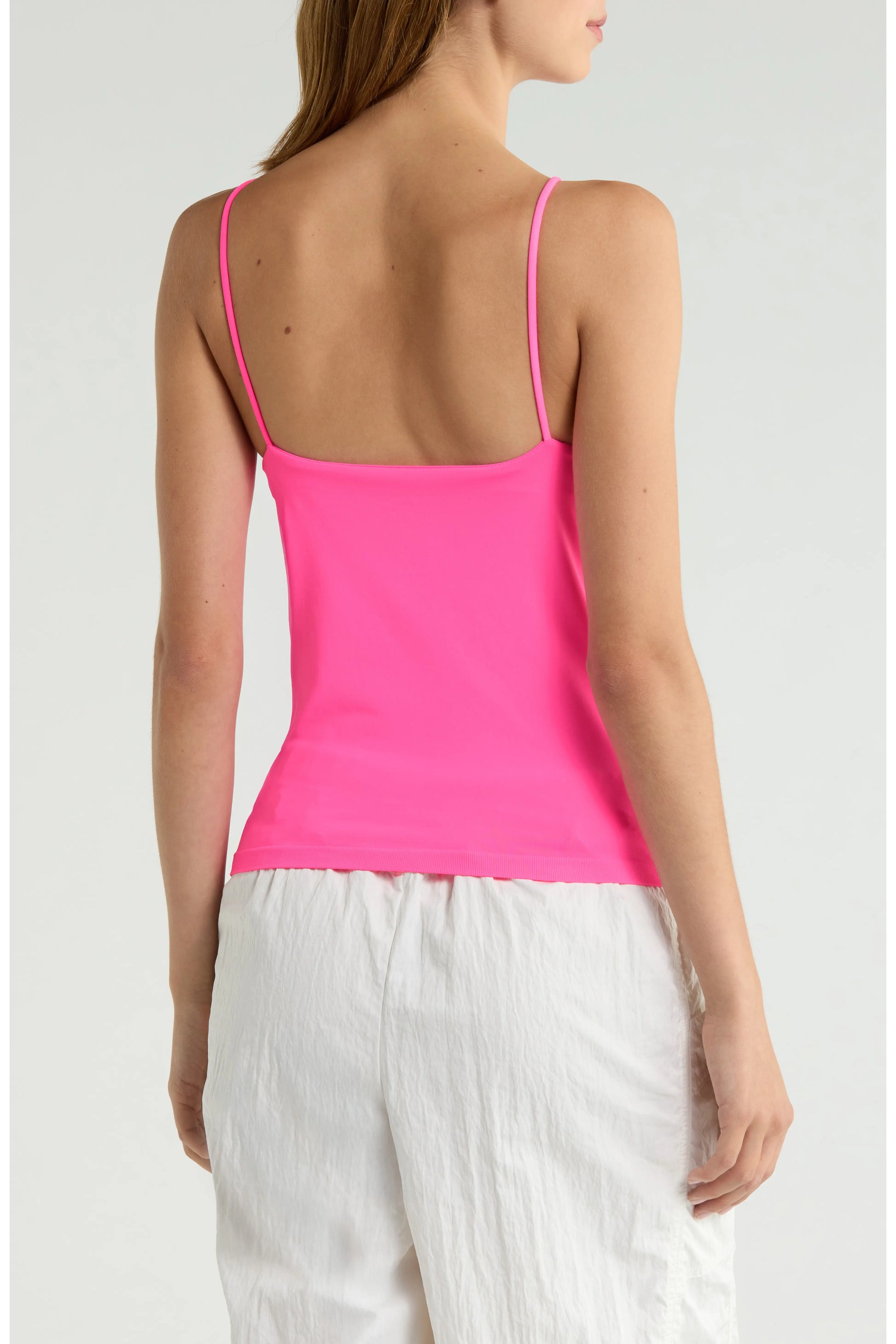 Britique Boutique model wearing Free People Hummingbird Pink Top showing back with white background