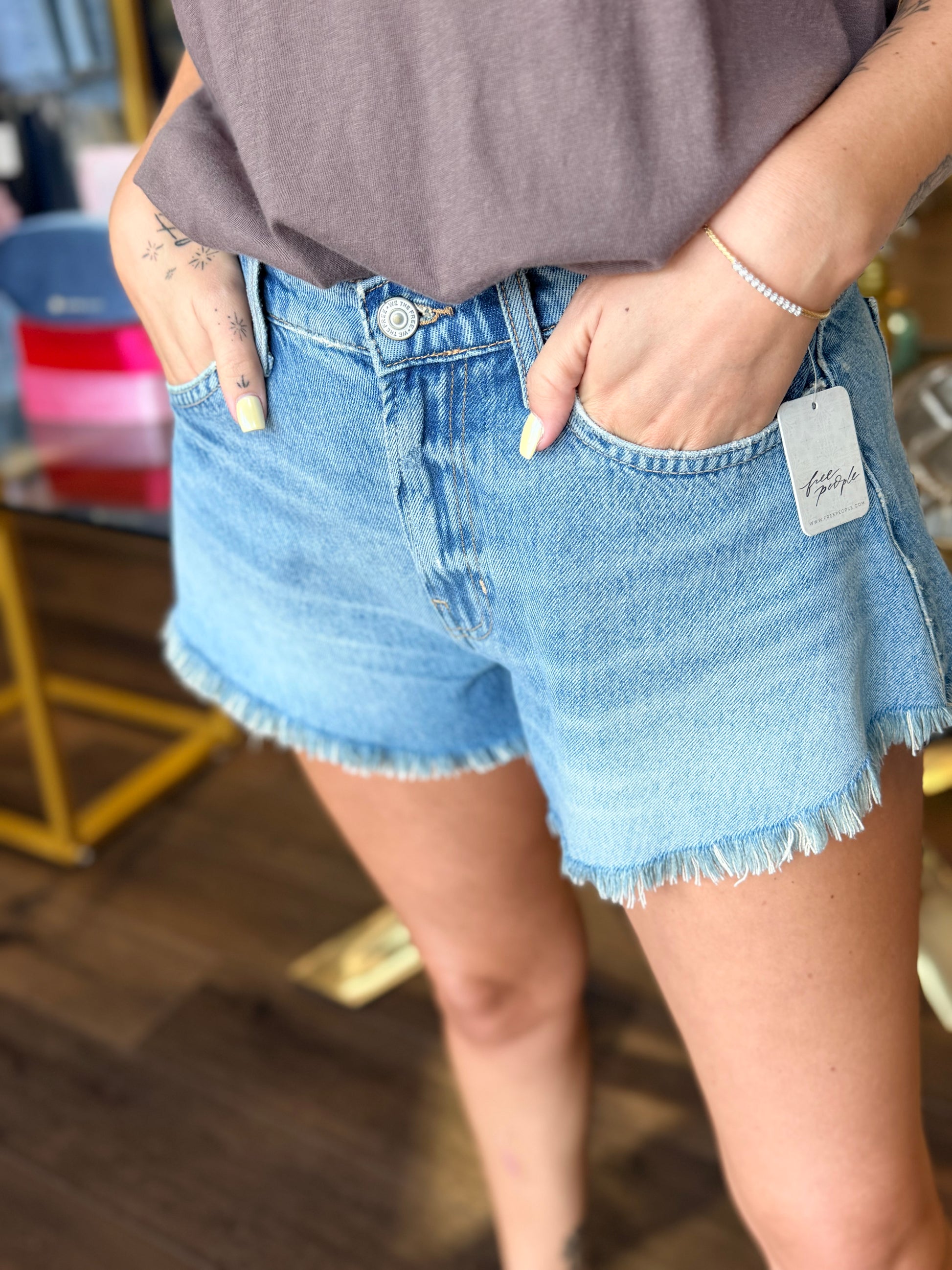Jean shorts in front of store 