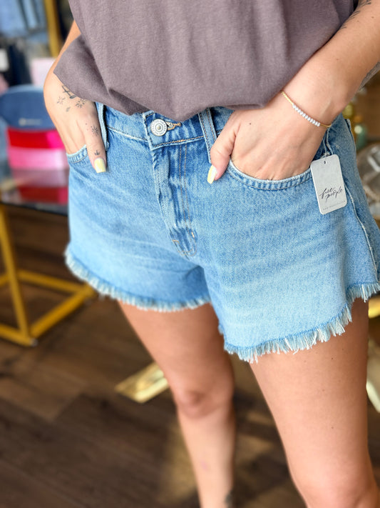 Jean shorts in front of store 