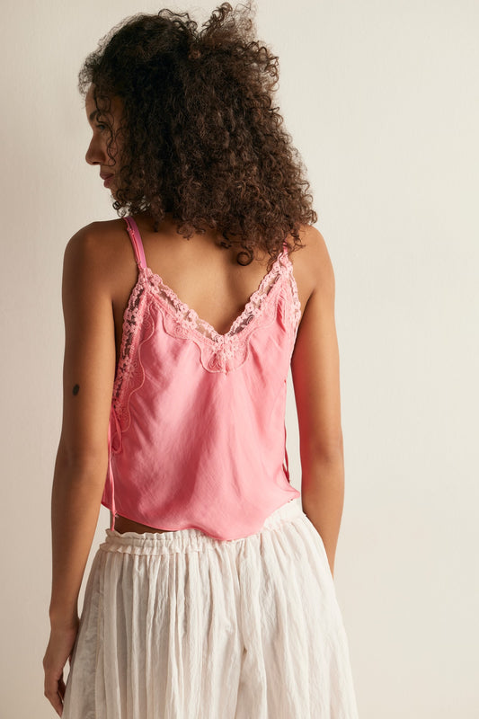 women wearing pink lace tank top standing facing backwards 