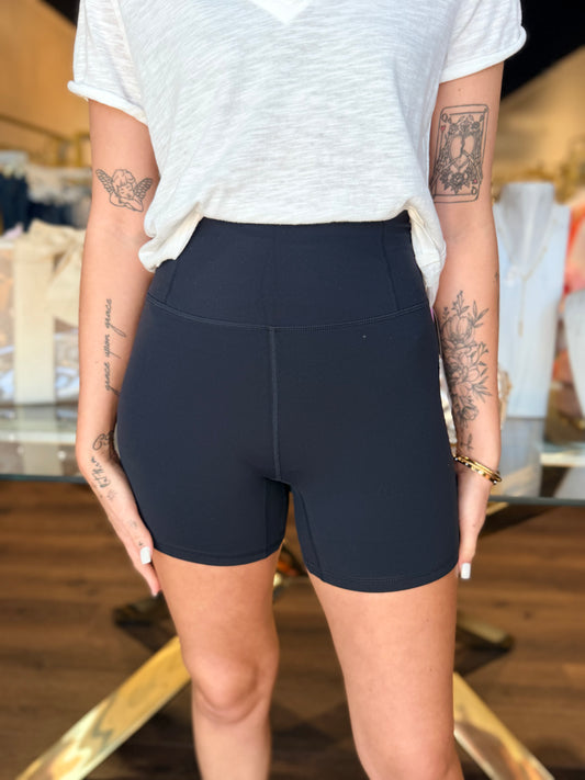model wearing black biker shorts