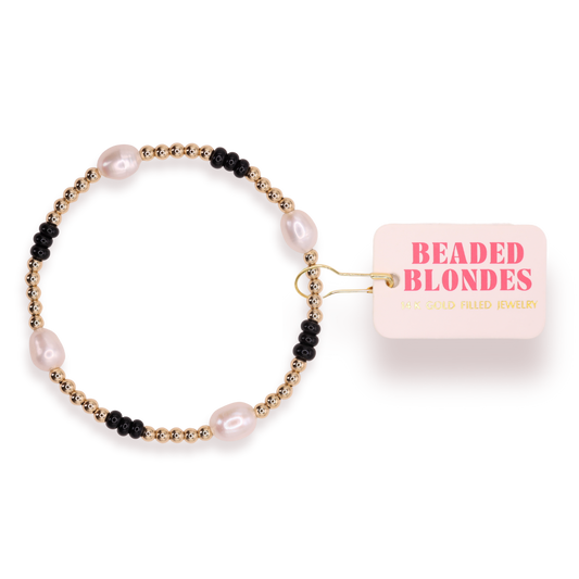 Beaded bracelet with pink label on a white background