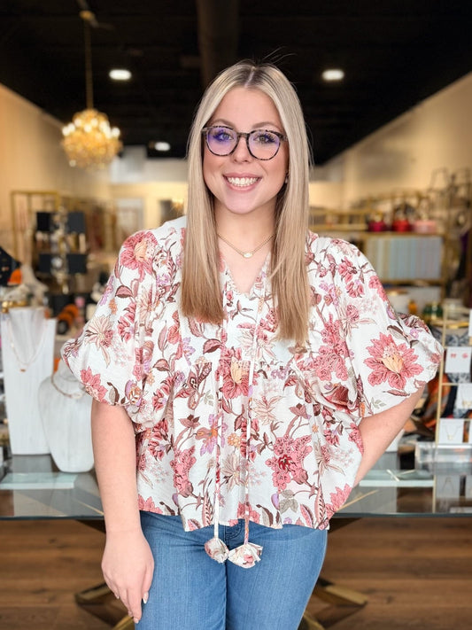 model wearing pink flower top with denim jeans