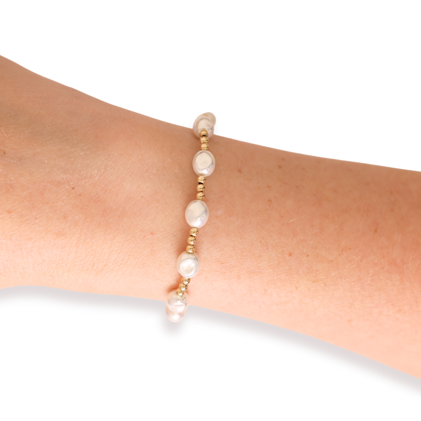 Pearl bracelet on a wrist against a white background