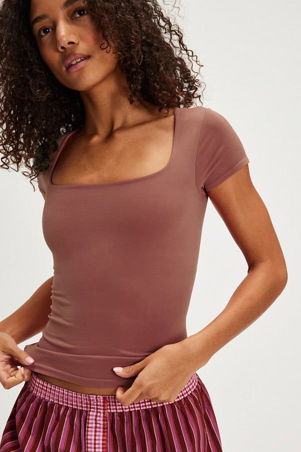 Model wearing brown short sleeve top