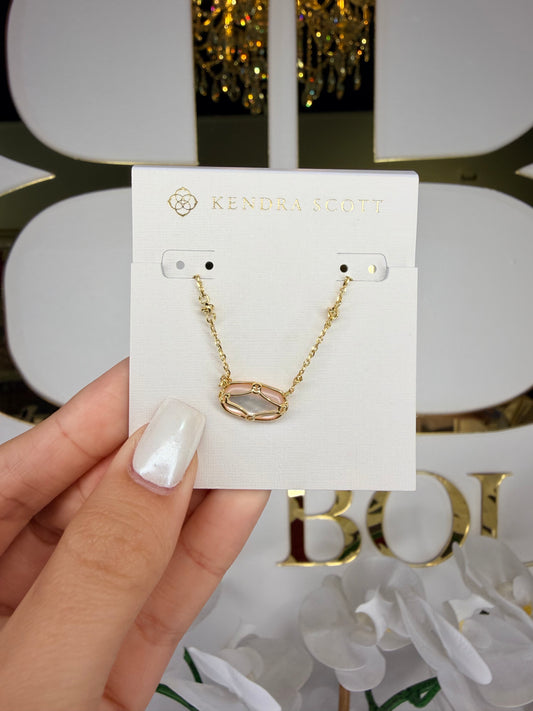 Gold Kendra Scott necklace with pink stone