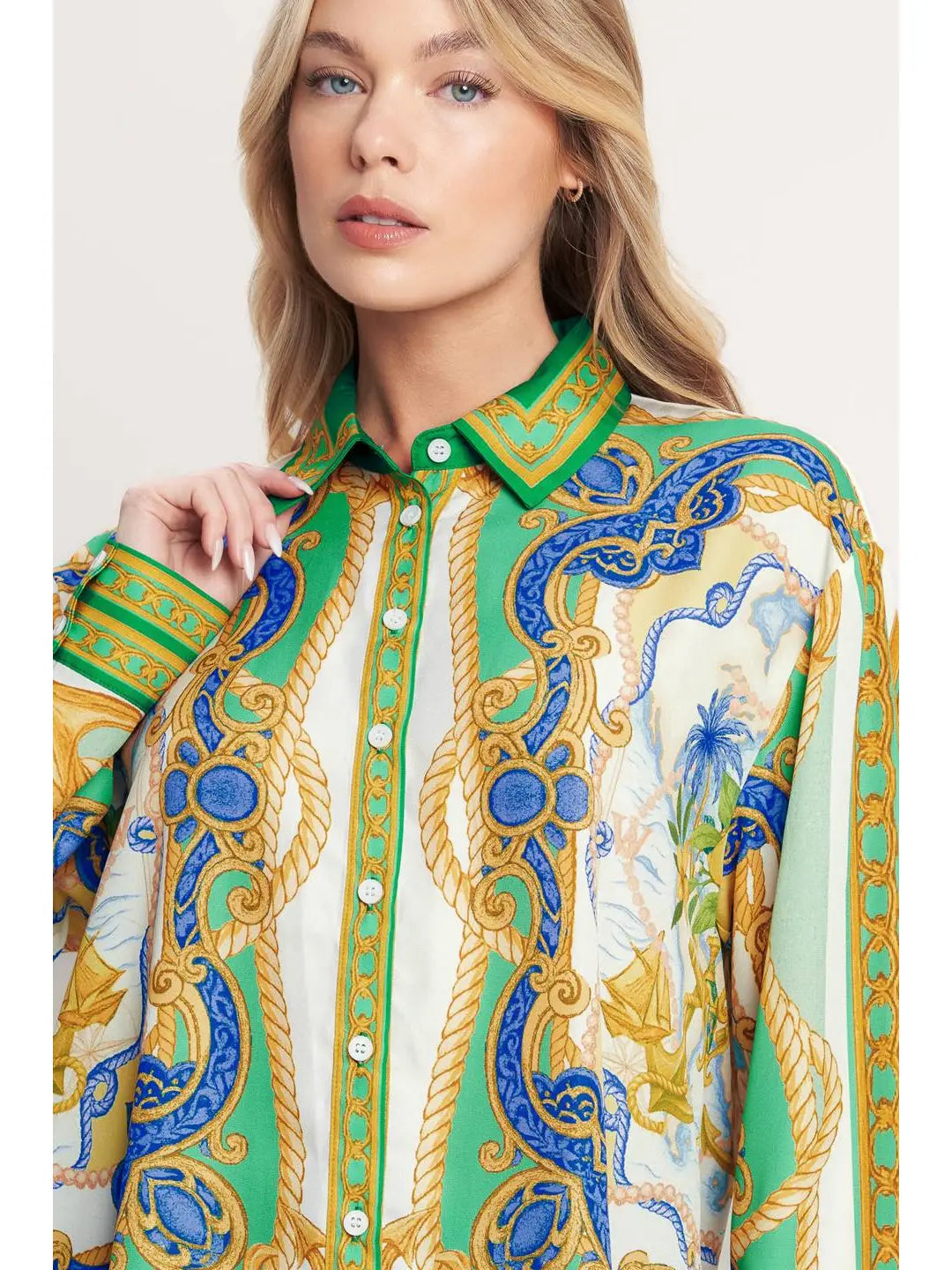 Woman wearing a colorful patterned shirt with a white background