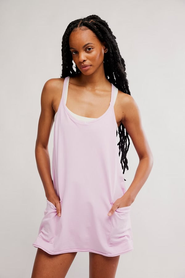 model wearing pink athletic mini dress facing forward 