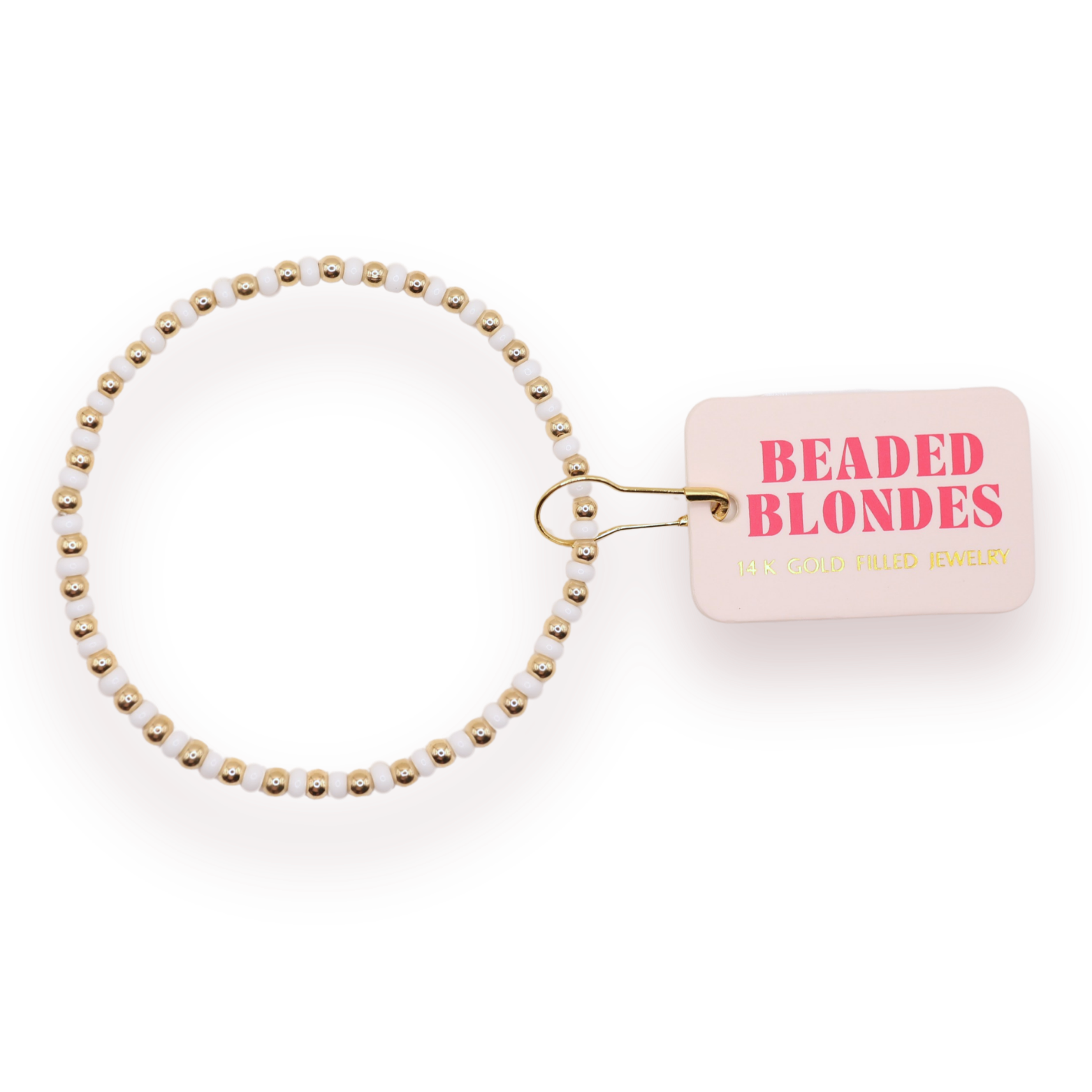 A beaded stretch bracelet with white beads and gold-toned spacer beads, attached to a small pink tag that reads 'BEADED BLONDE JEWELRY' in pink and gold lettering, on a white background.