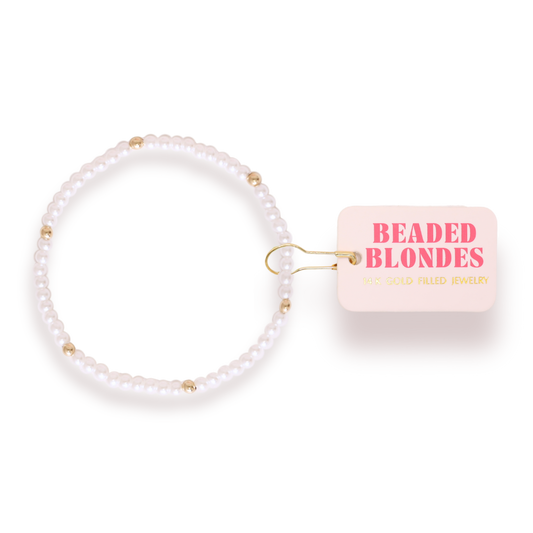 Pearl bracelet tie with 'Beaded Blondes' packaging on a white background
