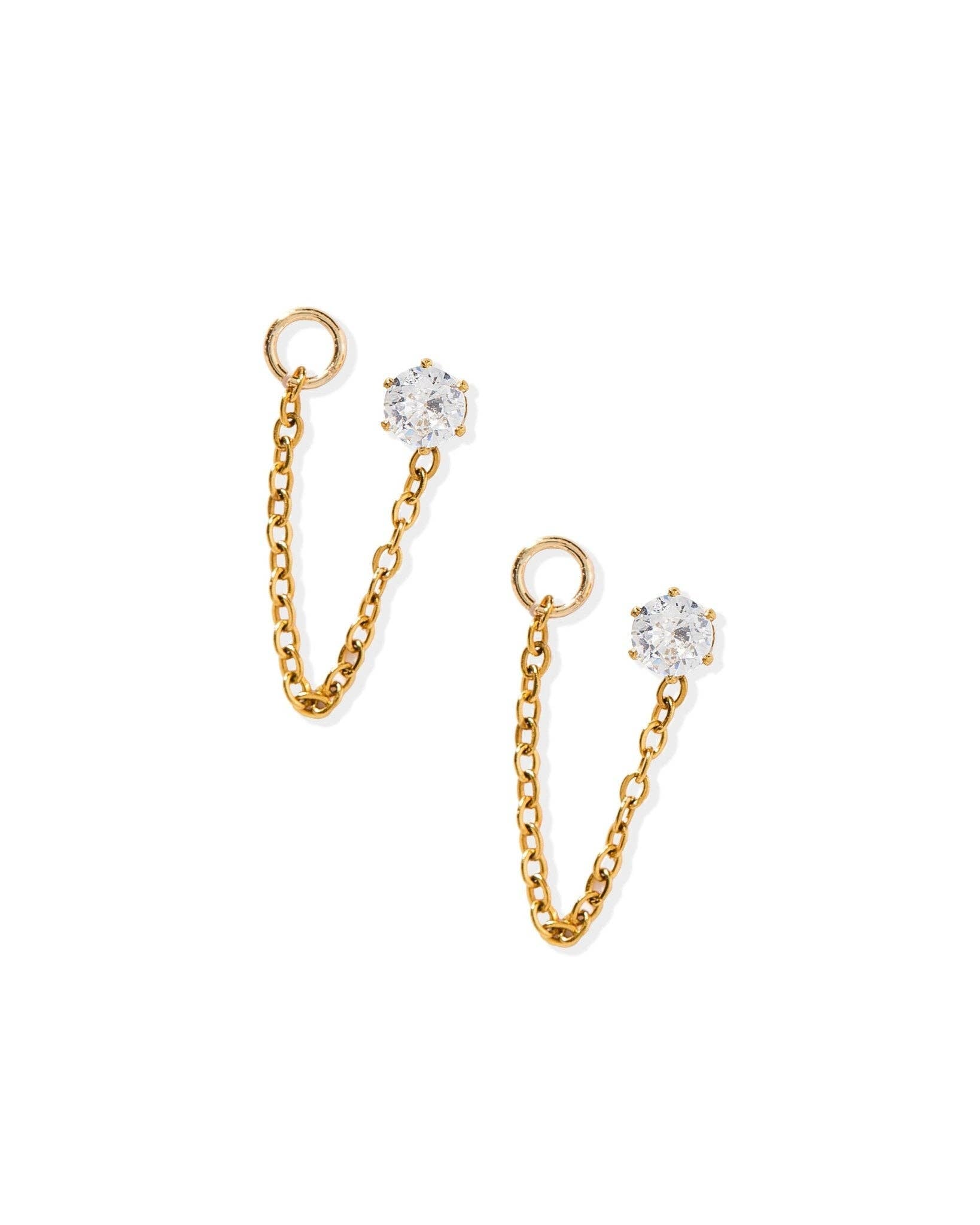 Gold chain earrings with clear gemstones on a white background