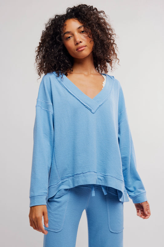 Woman wearing a blue outfit against a plain background