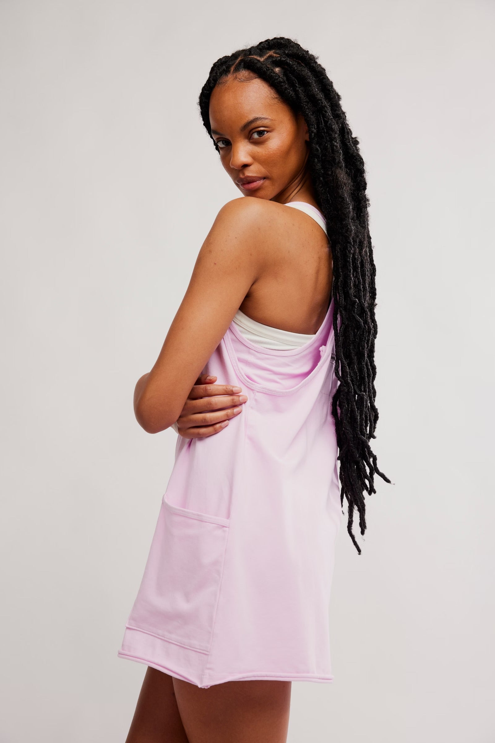 model wearing pink athletic mini dress facing sideways