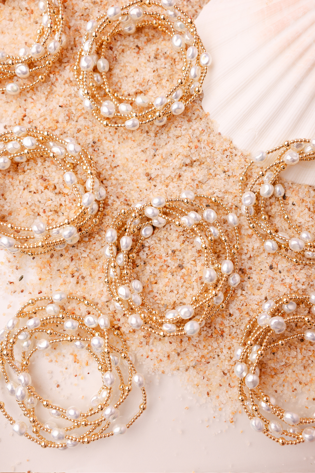 Gold and pearl hair accessories on a textured surface