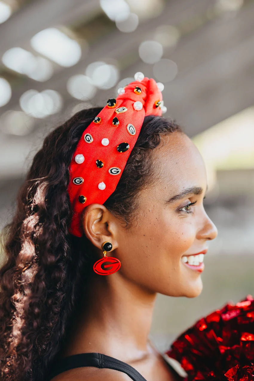Woman wearing a red headband with black polka dots and a blurred background