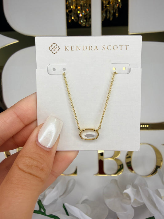 gold Kendra Scott necklace with white pendant
