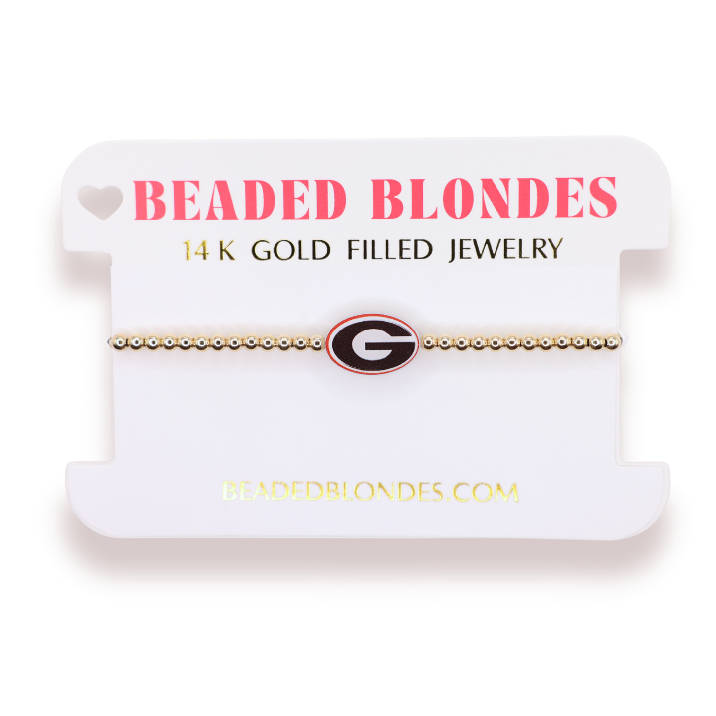 A gold beaded bracelet with a Georgia Bulldogs logo charm, displayed on a white branded card labeled 'BEADED BLONDES'.