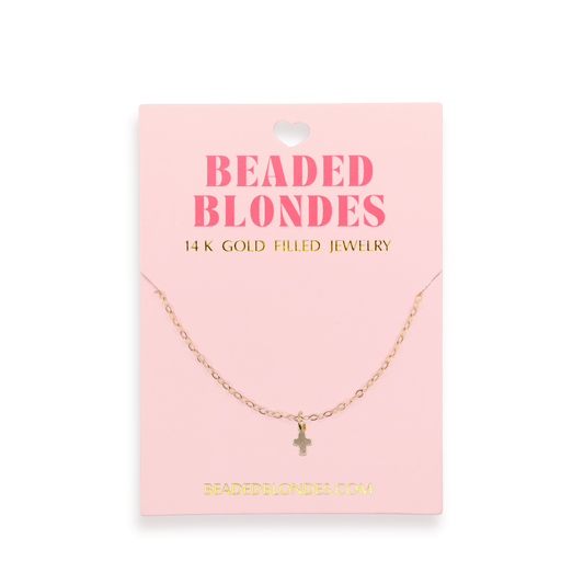Gold necklace on a pink card with 'Beaded Blondes' branding