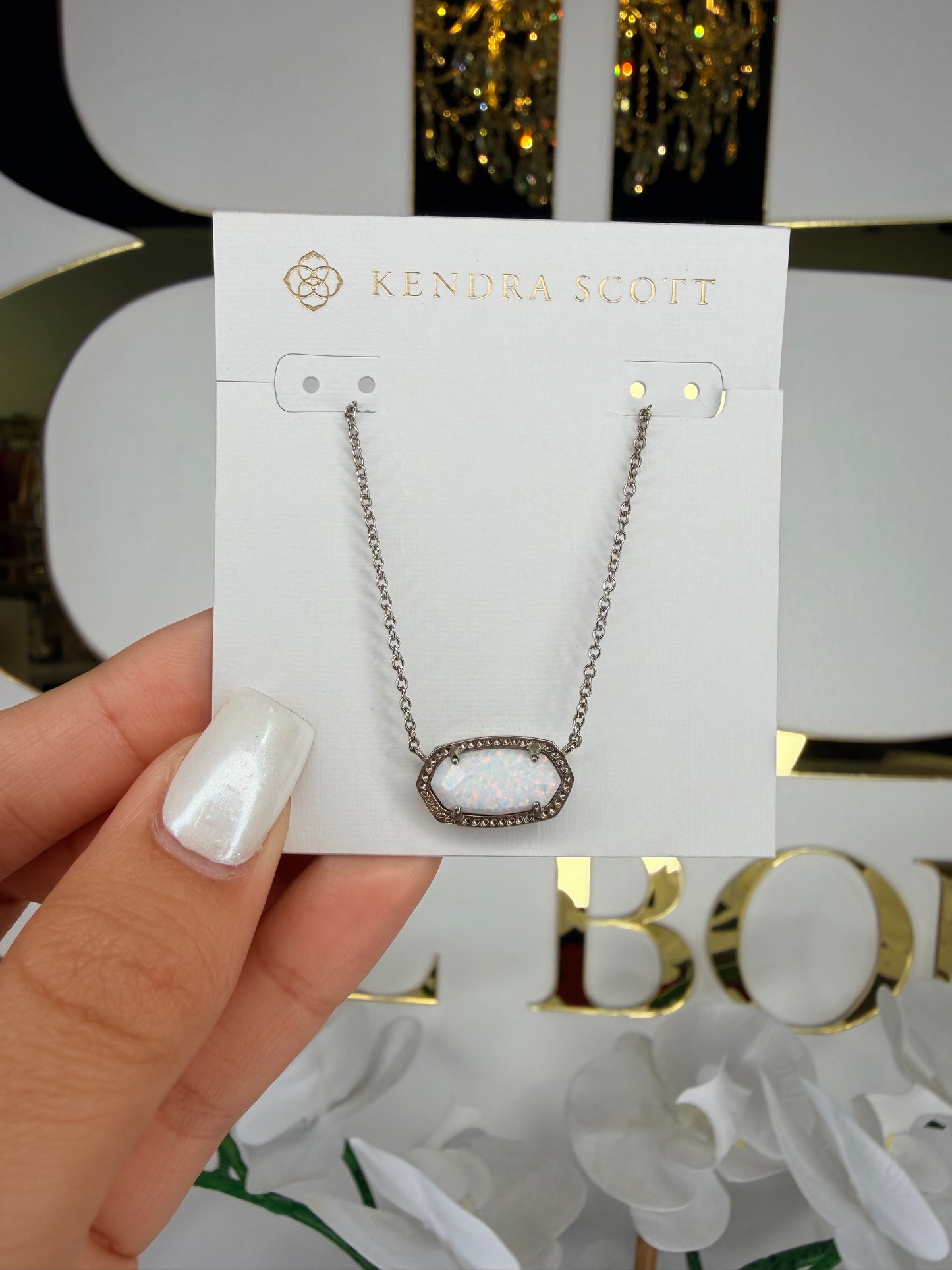 Silver Kendra Scott necklace with white opal pendant
