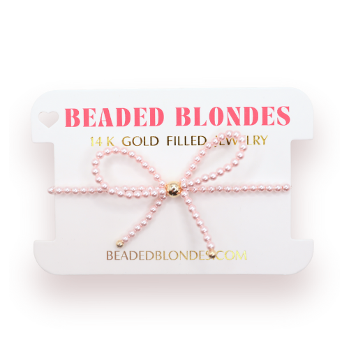Pink beaded bracelet on a 'Beaded Blondes' branded card with gold accents.