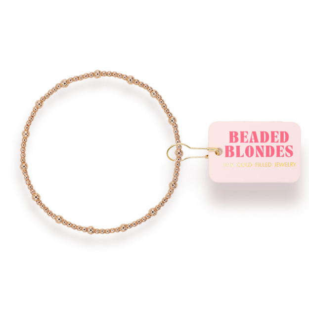 Gold and silver beaded bracelet with 'Beaded Blondes' label on a white background