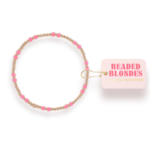 Beaded bracelet with pink and gold accents on a clear background, featuring 'Beaded Blondes' brand tag.