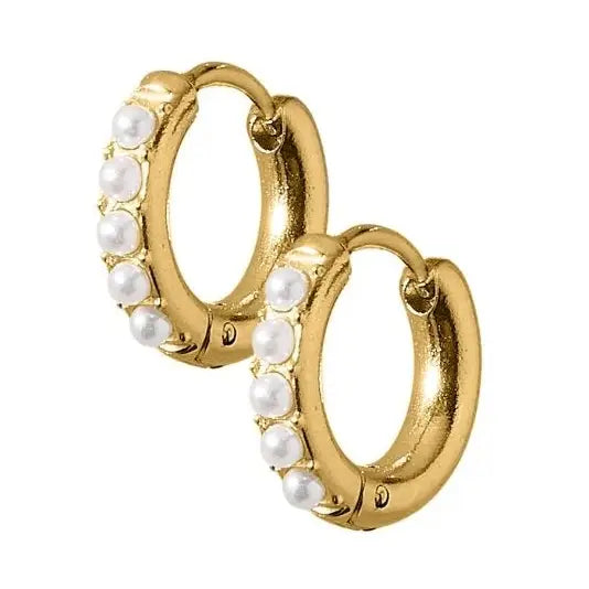 A pair of gold huggie hoop earrings decorated with a row of small white faux pearls along the front edge, set against a plain white background.