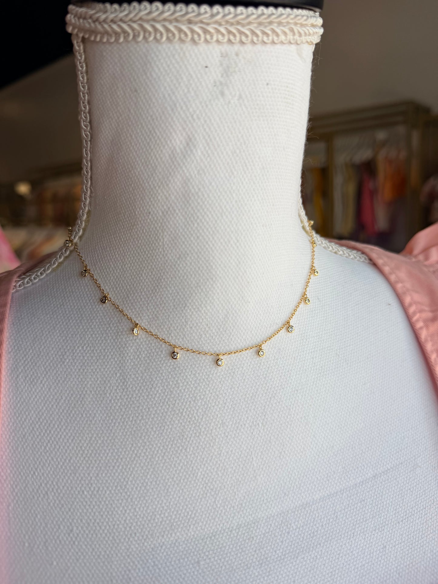 Gold kendra Scott necklace with crystal pendants