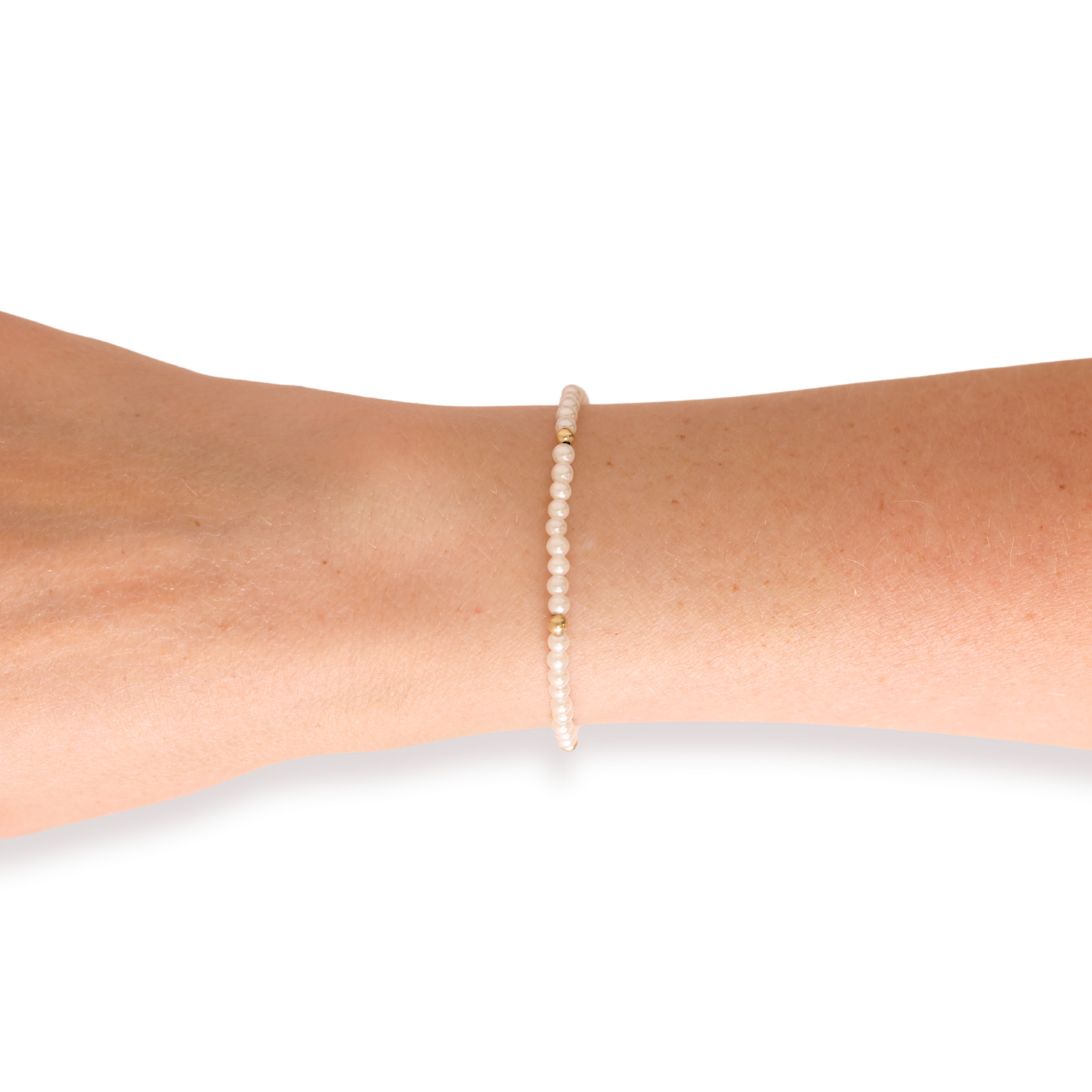 Pearl bracelet on a person's wrist against a white background
