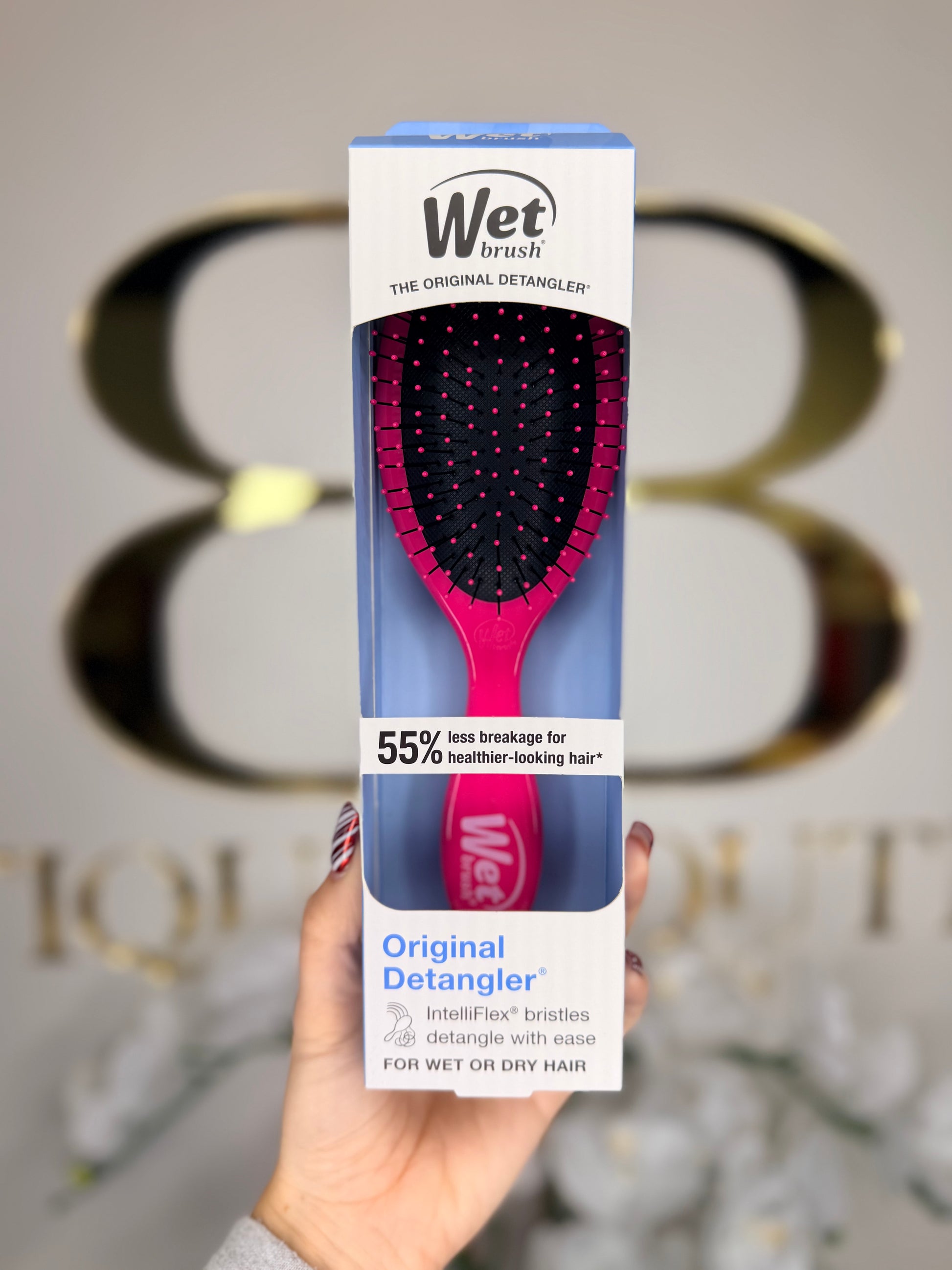 Wet Brush packaging held in front of a blurred background