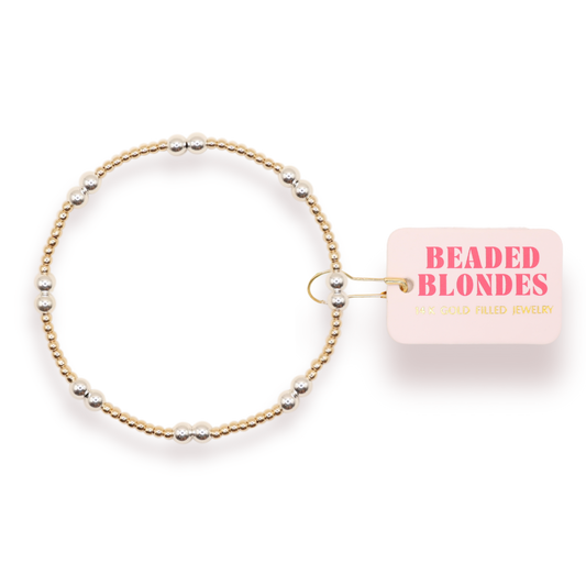 Beaded bracelet with 'Beaded Blondes' packaging on a white background