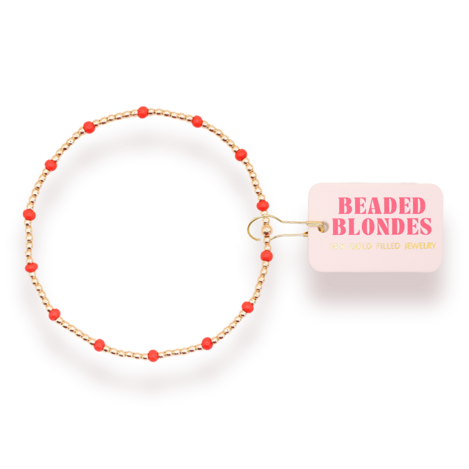 A gold-plated beaded bracelet with small red beads spaced along the chain, shown on a white background with a pink tag that reads 'BEADED BLONDES'.