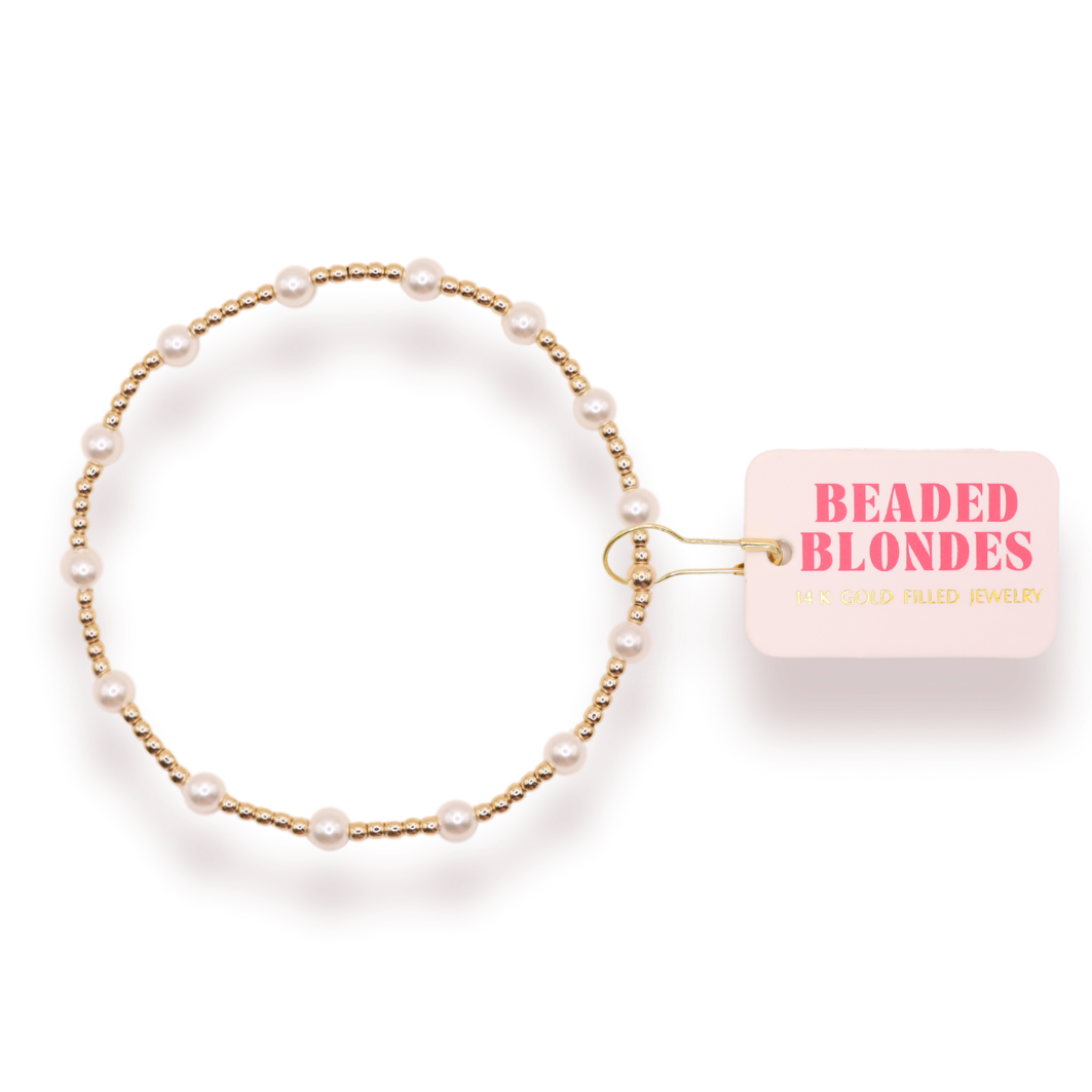 Pearl bracelet with a 'Beaded Blondes' card on a white background