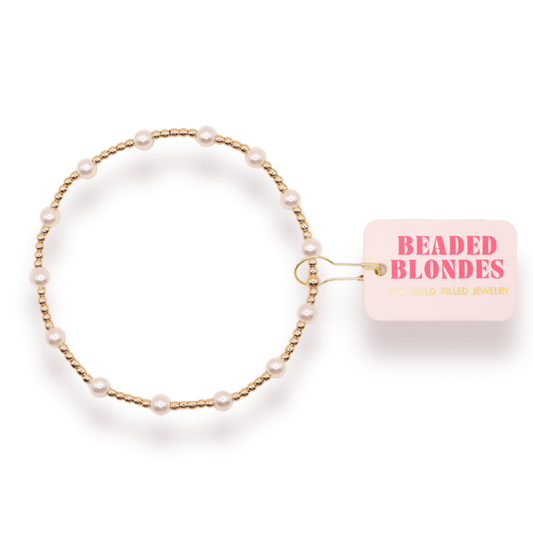 Pearl bracelet with a 'Beaded Blondes' card on a white background