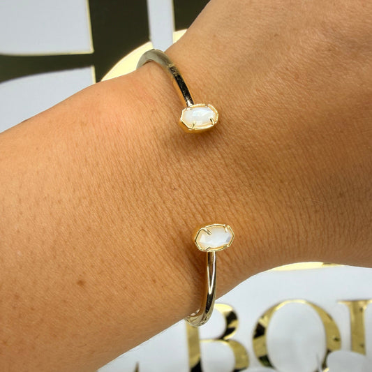 Mother of pearl kendra Scott small stone cuff in front of BB 