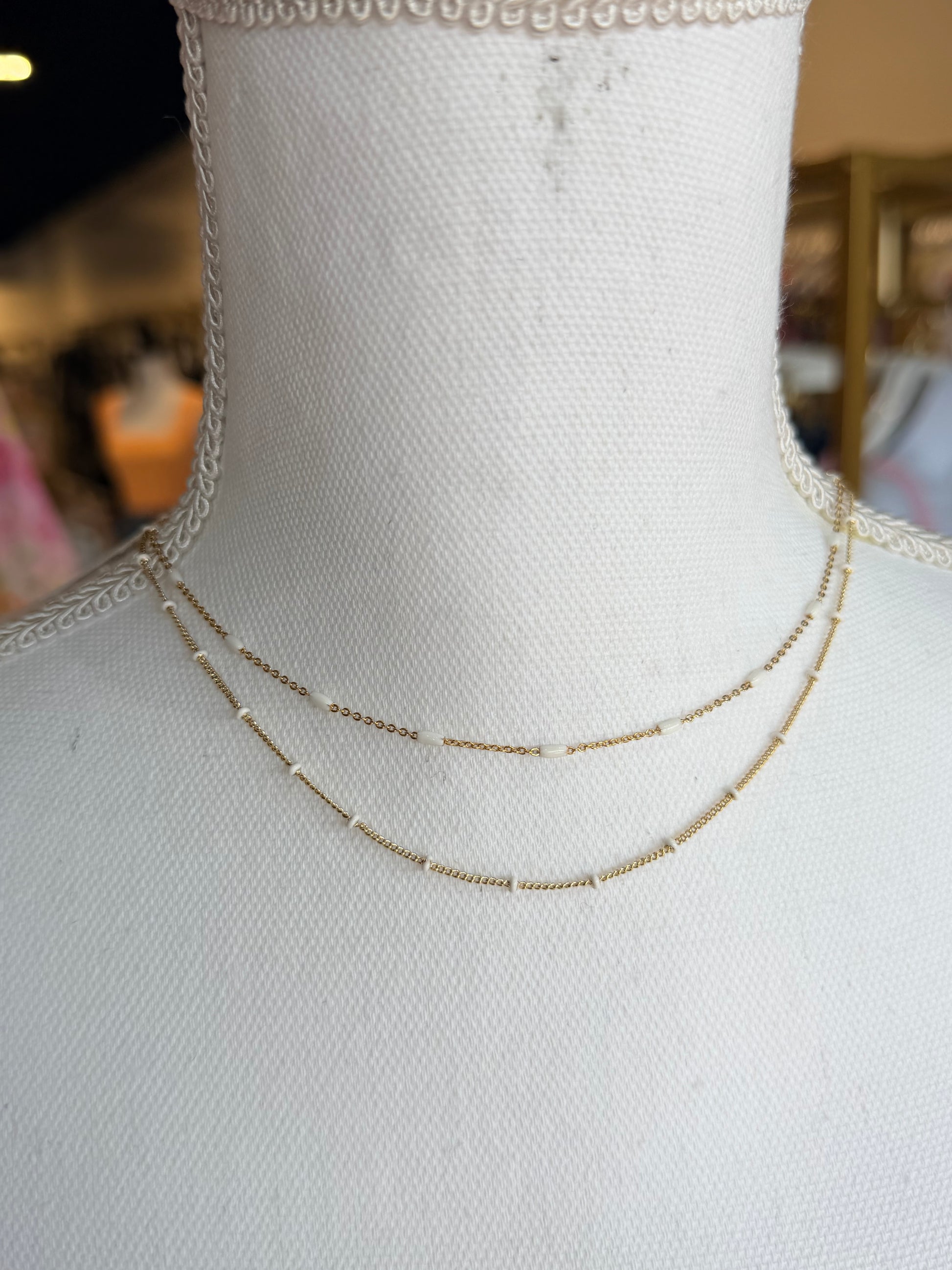 Gold double strand Kendra Scott necklace with white beads